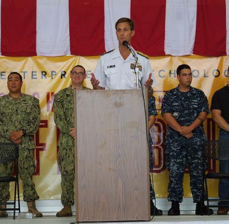 Rear Adm. Tim Gallaudet prepares to award certificates to the first students in a new maritime systems class.