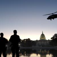 A stock photo of soldiers and a helicopter in front of the U.S. Capitol.