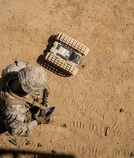 A U.S. Marine tests an unmanned ground robot. Photo: USMC