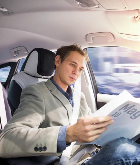 A man in a self-driving vehicle. Photo: iStock Photo