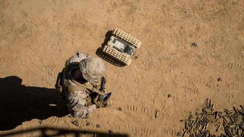 A U.S. Marine tests an unmanned ground robot. Photo: USMC