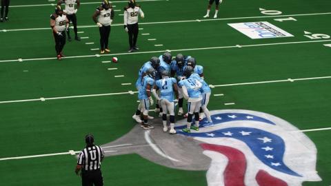 An unmanned aircraft flown by a staff pilot from Kansas State Polytechnic's Applied Aviation Research Center captures professional indoor football team Salina Liberty in a huddle at a game on March 3 against the Wichita Force.