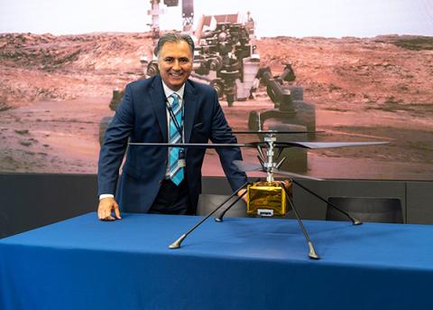 AV's CEO poses with a model of the Mars Helicopter. Photo: AeroVironment