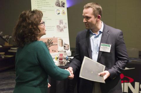 LiquidPiston CEO Alex Shkolnik accepts his company's award from AUVSI Executive Vice President Heather Lee. Photo: AUVSI